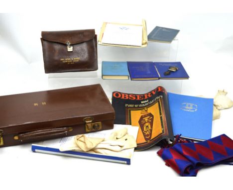 A leather case containing a quantity of Masonic regalia to include gloves, apron, sash etc, various books, 'The Masonic Handb