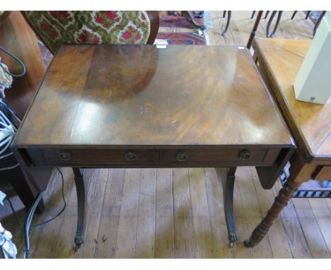 A reproduction mahogany sofa table, the drop leaves over two frieze drawers on reeded outsplayed legs, 74cm wide (leaves clos