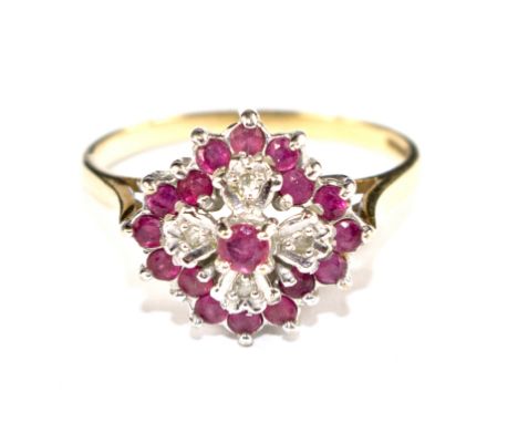 A ruby and diamond cluster ring set in 9 carat gold