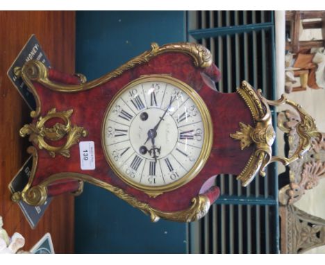 A 19th century tortoiseshell and giltmetal mantel clock, of shaped form with scrolled mounts, the enamelled dial inscribed Ed