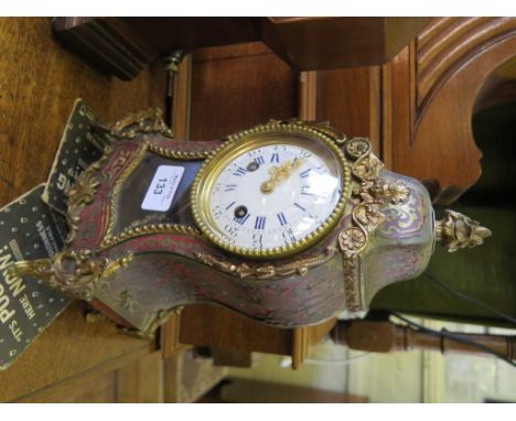 A 19th century French Boullework table clock, the shaped case with gilt metal mounts, the enamel dial with twin train countwh