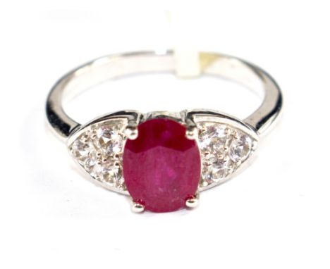 A ruby and white sapphire ring set in 9 carat white gold