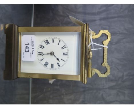 A brass carriage clock, with enamel dial, the top inscribed and dated October 1905, French movement striking on a gong, 16cm 