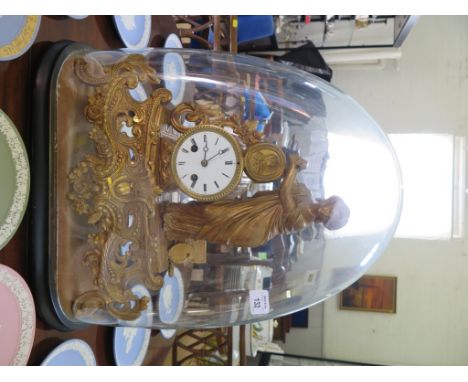 A Victorian gilt metal mantel clock, depicting a figure and artists materials next to the drum dial on a scrolling base, with