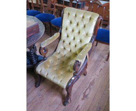 A Victorian mahogany armchair, the scroll button back and seat on outsplayed legs with hoof feet