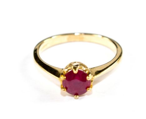 A single stone ruby ring set in 9 carat yellow gold