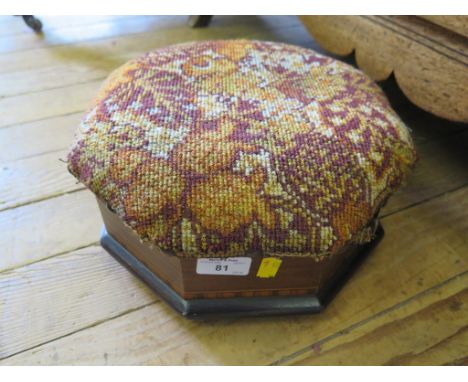 A Victorian chequerbanded octagonal footstool with upholstered hinged top enclosing a brown glaze spitoon, on white ceramic f