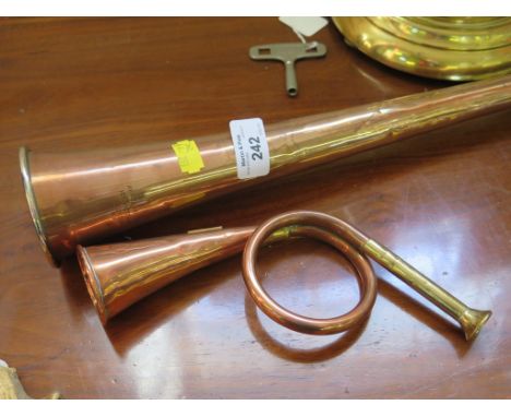 A copper and white metal coaching horn stamped Army & Navy C.S.L. 105 Victoria Street London S.W. 83cm long, and a copper hun