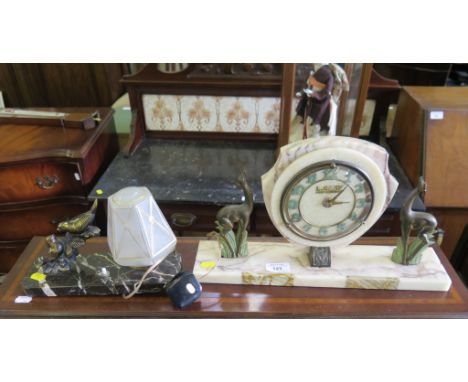 A 1920's French Art Deco marble mantel clock, the shield shape dial inscribed L. Cany, Point Audemer, flanked by figures of d