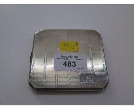 A silver cigarette case with engine turned decoration 