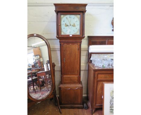 An early 19th Century oak long case clock, with fluted pillars and pilasters and shaped trunk panels, enclosing a square pain