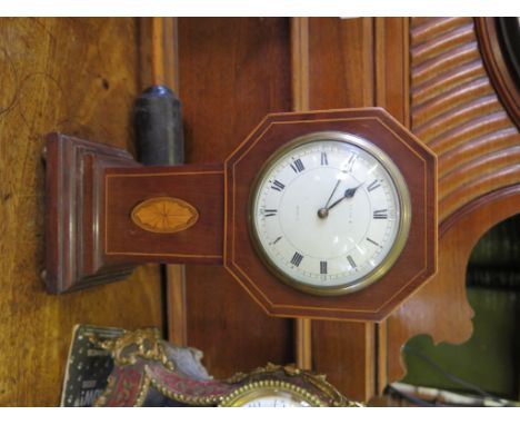 An Edwardian mahogany and boxwood mantel timepiece, of octagonal form with patera inlay to the stem, the enamel dial indistin