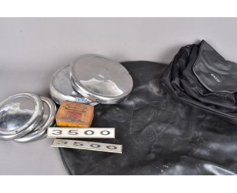A selection of automotive items, to include two sets of vintage car hub caps, two 3500 car badges, a BMW back pack, a Dunlop 