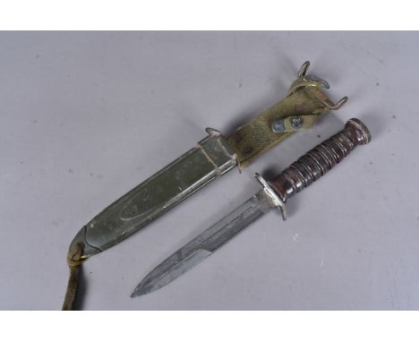 A US M3 Camillus Fighting knife, with turned wooden handle, stamped to the pommel, together with scabbard and frog