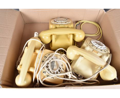 The vintage cream coloured Rotary telephones, all with receivers