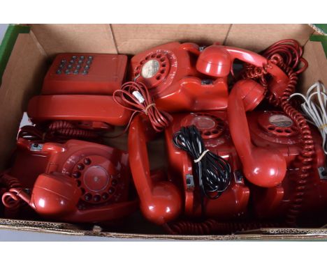 A group of vintage red plastic telephones, to include four Rotary examples and a push button example, all with there reciever