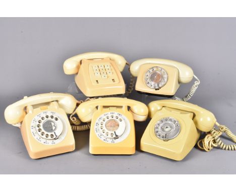A group of five light colours vintage telephones, three larger rotary examples, plus a smaller example and a push button exam