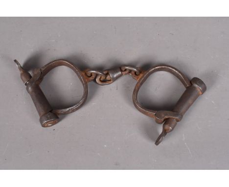 A pair of Military issue Hyatt hand restraints, marked with a broad arrow and dated 11