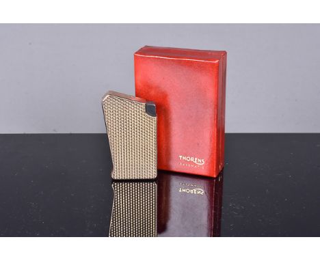 A gold plated Thorens Gasomatic lighter, c1960, with repeating geometric engine turned design, in original red presentation b