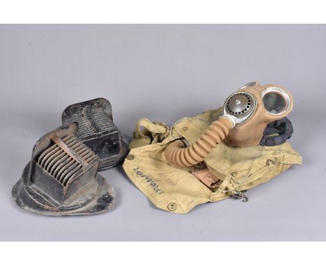A WWII Gas Mask, stamped with broad arrow and dated 1939, complete with filter and pipe, on the pipe a dog tag for '2QW 68982