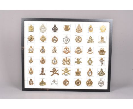 An array of 35 British cap badges, to include Tank Corps, RAF, RFC, Reconnaissance Corps, Army Cyclist Corps, Intelligence Co