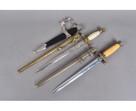 A reproduction Kreigsmarine dagger, by WKC, with etched double fullered blade and scabbard, together with a reproduction Germ