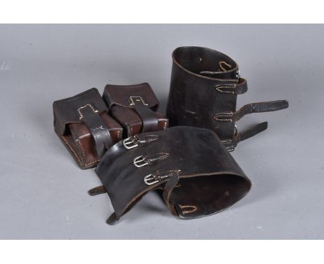 A pair of brown leather military spats, with three buckles, together with a two compartment brown leather ammo pouch, stamped
