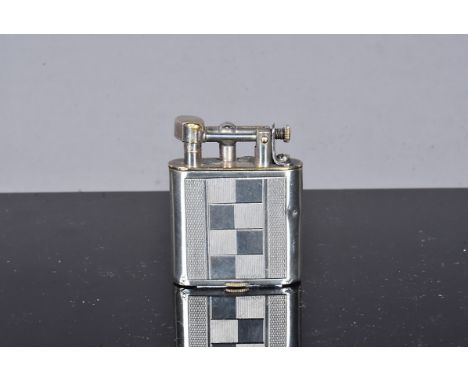 A Sarastro German silver manufactured petrol pocket lighter, with liftarm, silver jacket with geometric engine turned design,