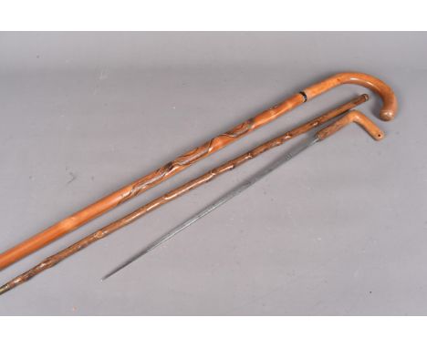 An early 20th Century sword stick, with 44cm long engraved blade, together with a Spanish Toledo example (2)