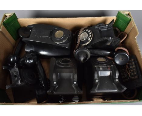 A collection of black plastic vintage telephones, including one rotary example and the other call exchange examples, AF