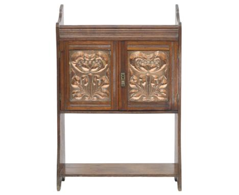 A LATE 19TH CENTURY ASH ARTS &amp; CRAFTS SMOKERS CABINET&nbsp; with pair of panel doors with hammered copper doors embossed 