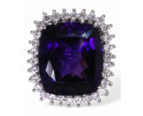 AMETHYST &amp; DIAMOND RING set in 18k white gold classic basket mount with a large cushion cut amethyst to the centre, surro