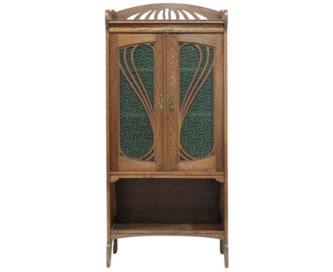 AN EARLY 20TH CENTURY OAK ARTS & CRAFTS STAINED GLASS CABINET  with stylized pierced gallery top over pair of mottled stained