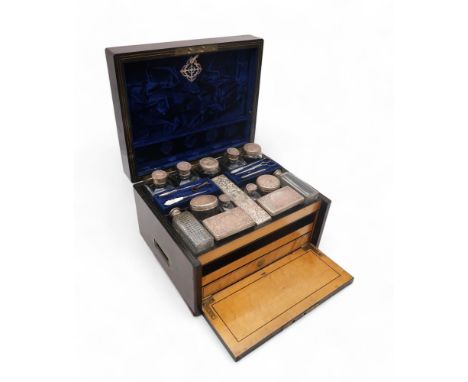 A VICTORIAN SILVER COROMANDEL & SATINWOOD TRAVELLING TOILET BOX rectangular with hinged cover inset with a monogrammed brass 
