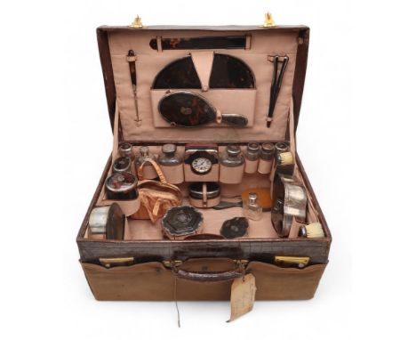 A MATCHED SILVER &amp; TORTOISESHELL CROCODILE LEATHER TRAVELLING VANITY CASE comprising four boxes, six tortoiseshell silver