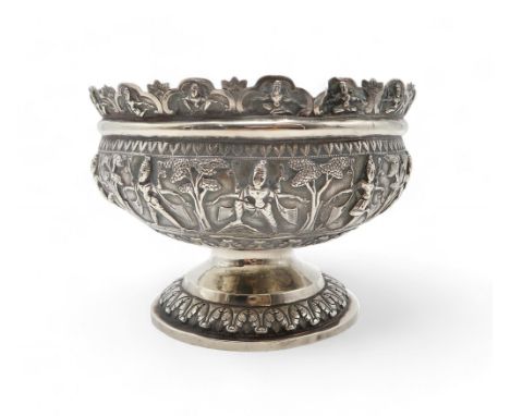AN INDIAN SILVER FOOTED BOWL chased in high relief, depicting aspara amongst trees, the decoration continued on the rim, with