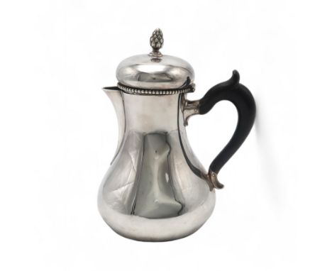 A DUTCH SILVER COFFEE POT of baluster form, with a beaded rim and pineapple finial, with a carved ebonised scroll handle, 19t