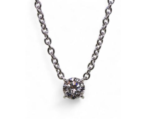A CARTIER DIAMOND PENDANT known as the 1895 necklace, the solitaire diamond is four claw set to a fine trace chain, with a ba