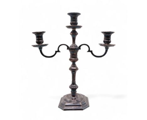 AN ELIZABETH II SILVER TWIN BRANCH CANDELABRA by Roberts &amp; Belk, Sheffield 1977, filled, of faceted form, with a knopped 