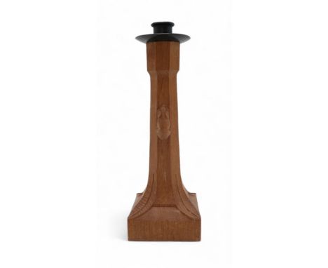 WORKSHOP OF ROBERT MOUSEMAN THOMPSON  An oak candlestick, with wrought iron sconce, with octagonal column with carved mouse, 