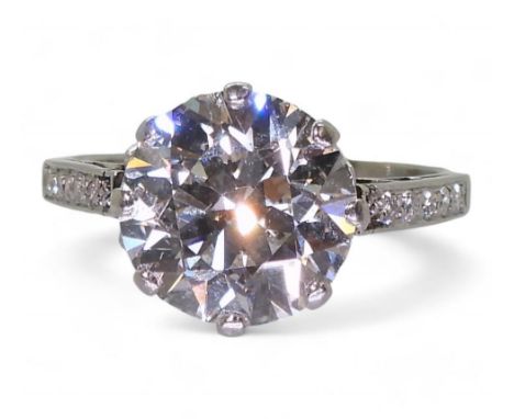 A SUBSTANTIAL DIAMOND RING the diamond is estimated approx at 4cts, mounted in platinum, with a pretty galleried mount with e