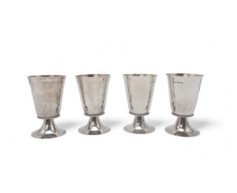 GARRARD &amp; CO; a set of four George V silver chalices, London 1932 / 33, of flaring form, the bodies hammered, with an app