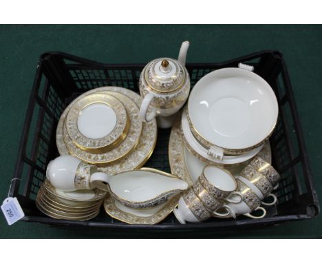 A Wedgwood 'Gold Florentine' part dinner and tea service comprising of a meat plate, two tureens (one lacking lid), five dinn