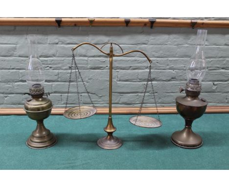 Two vintage brass oil lamps plus a brass set of balance scales