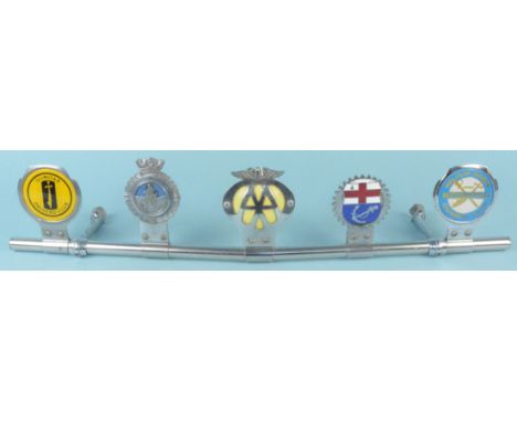 Five vintage car badges mounted on a metal bar, includes Scimitar Drivers club, AA etc
