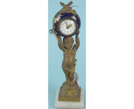 A 19th Century French gilded metal cherub supporting a ceramic clock, 30cm tall with key