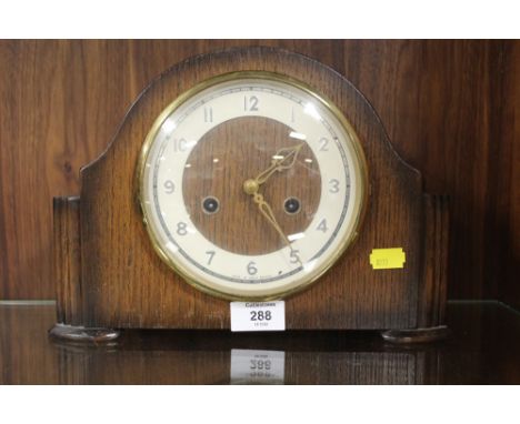 A VINTAGE OAK CASED MANTEL CLOCK