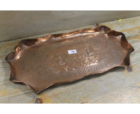 A WIDE COPPER TRAY, with decorative central vignette of a old copper mine and engine houses, hand hammered in a  Eustace Brot