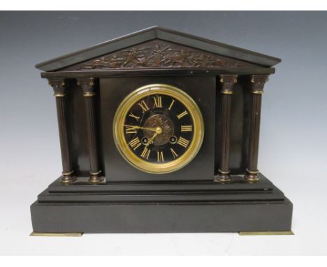 A BLACK SLATE GONG STRIKE MANTLE CLOCK, of architectural form with reeded columns and a black slate dial, H 27 cm, W 35 cmCon