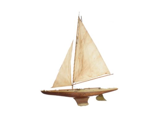 A Pond Yacht, with painted brown hull and cream deck, with ‘Snuff Box’ Hatch cover, leaded keel, masts, sails and some fittin